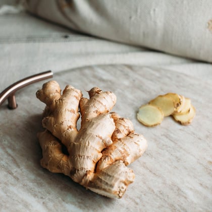 a clump of ginger root on a round marble cooking slab